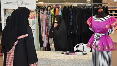 A woman sells clothes at a charity bazaar organised by Zayed University to help those affected by the earthquake in Nepal