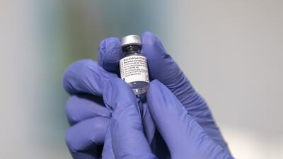 A nurse handles a vial of the Pfizer-BioNTech Covid-19 vaccine. Bloomberg.