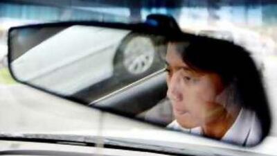 Arlene Tan, one of Abu Dhabi's few female taxi drivers, behind the wheel of her car.