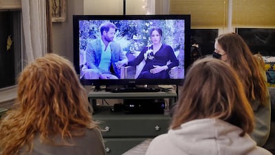 People watch Prince Harry and Meghan Markle's interview with Oprah Winfrey in Arlington, Virginia, on March 7, 2021. AFP