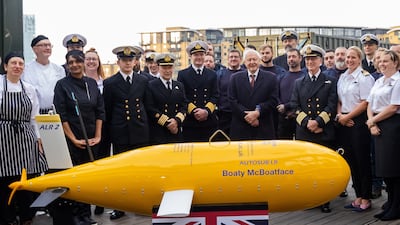 David Attenborough and crew members with Boaty McBoatface, a submersible on the ship that was named in a competition. EPA