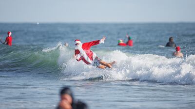 Florida's Santa surf event began in 2009. Reuters