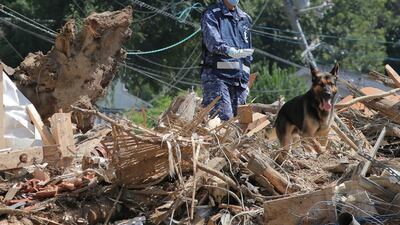 A member of Maritime Self Defense Forces searches for missing persons at a flood damage site in Kure, Hiroshima prefecture on July 12, 2018. AFP