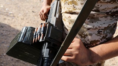 A member of Libya's internationally recognised government forces carries a weapon in Ain Zara, Tripoli. Reuters