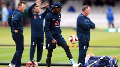 England’s Jofra Archer does kick ups with a football as they inspect the pitch. Mike Egerton / PA Wire