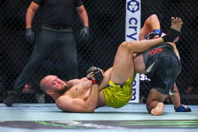 Valter Walker looks for a leg lock against Thomas Petersen at UFC Fight Night in Abu Dhabi on July 25. Victor Besa / The National