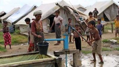 A Muslim boy fetches water from a pump inside a refugee camp in Sittwe, Rakhine state, western Myanmar.