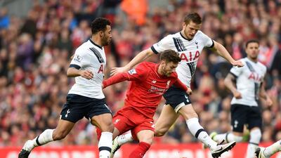 Adam Lallana, centre, of Liverpool competes for the ball against Mousa Dembele, left, and Eric Dier of Tottenham. Michael Regan / Getty Images