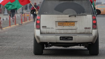 A supporter waves the flag of Oman, from a car in Iraq's southern city of Basra, on January 16, before the Arabian Gulf Cup semi-final football match between Bahrain and Oman. AFP