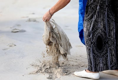 Plastic bags were found buried in sand during Zero Gravity's beach clean-up on Sunday, September 1. Satish Kumar / The National