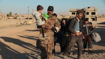 A medic at an Iraqi special forces field hospital lends a helping hand to civilians escaping the fighting in eastern Mosul on November 20,2016. Florian Neuhof for The National