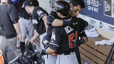 Miami Marlins player Ichiro Suzuki is congratulated in the dugout by Christian Yelich, right, after their 6-3 loss against the San Diego Padres in a baseball game, Wednesday, June 15, 2016, in San Diego. (Gregory Bull/AP Photo)