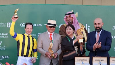 Christophe Lemaire receives the trophy after winning the Longines Red Sea Turf Handicap with his horse Stay Foolish. Reuters