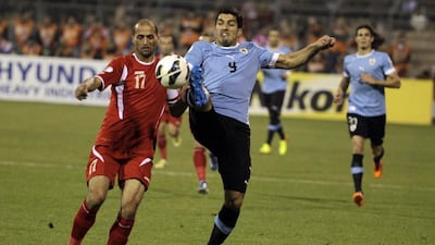Luis Suarez, centre, and Uruguay are well on their way to the 2014 World Cup after a comprehensive 5-0 victory in Jordan. Khalil Mazraawi / AFP