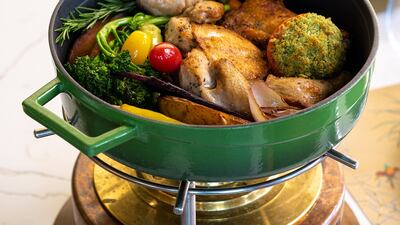 Oven-roasted baby chicken, marinated with herbs and garlic served with ratatouille nicoise, baby carrots and chicken jus from Raclette Brasserie & Cafe.