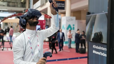 A man tests a VR game at the event. Reem Mohammed / The National