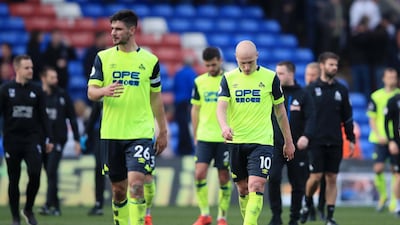 Huddersfield Town players look dejected as they leave the pitch. Getty Images