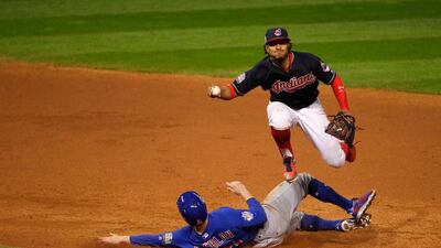 Francisco Lindor of the Cleveland Indians jumps over Chris Coghlan to force Coghlan out at second base in the ninth inning. Jamie Squire / Getty Images