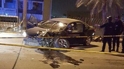 Security forces examine the site of a bomb blast that killed a Bahraini woman and injured three children on June 30, 2016. Interior ministry of Bahrain via AP