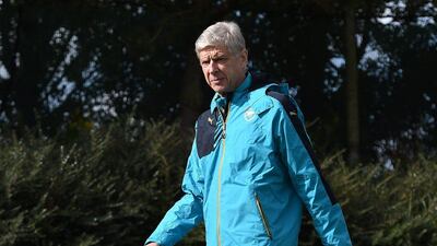 Arsenal manager Arsene Wenger observes his team as he conducts a training session on Monday for their Champions League match on Tuesday. Andy Rain / EPA