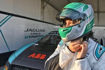 Reema Juffali fastens her helmet in front of her car ahead of the Jaguar I-Pace e-Trophy race. AFP