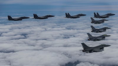 A South Korea Defence Ministry photo of F15K fighter jets and US Air Force F-16s flying in formation during a joint drill. AP