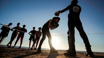 Palestinian girls take part in an open-air boxing training near the beach in Gaza City. AFP