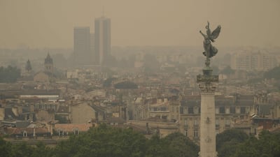 Smoke from nearby 'unpredictable' wildfires cover the Bordeaux city skyline on July 26. AFP