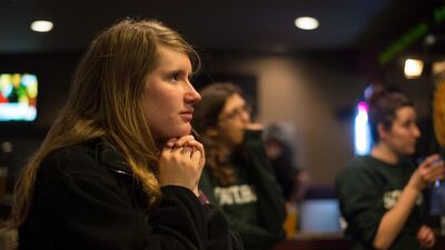A volunteer of the Hillary Clinton Burlington, Iowa campaign field office looks on as Hillary Clinton speaks on the television at the Boogaloo Cafe on February 1 in Burlington, Iowa. Michael B Thomas / AFP
