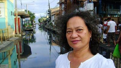 Nimfa Tan Gana seen in one of the flooded areas in the Lingga barangay of Calamba, 54km south-east of Manila.