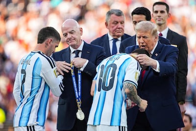 FIFA President Gianni Infantino and U. S. President Donald Trump present the runners-up medal to Rodrigo De Paul #7 and Lionel Messi #10 of Argentina after the FIFA World Cup 2026 Final match between Spain and Argentina at New York New Jersey Stadium on July 19, 2026 in East Rutherford, New Jersey. Spain defeated reigning World Cup champions Argentina, who were led by Lionel Messi, with the lone goal coming from Ferran Torres #7 in the 106th minute of extra time. AFP