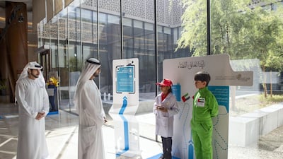 Sheikh Mohammed and the Sheikh Hamdan bin Mohammed look at the tribute to the KhalifaSat launch at Union House.