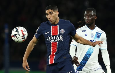 Paris Saint-Germain's Moroccan defender Achraf Hakimi, left, controls the ball against Auxerre. AFP