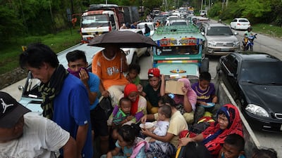 Resident flee from Marawi city where an ISIL-inspired group of gunmen rampaged through the city in Mindanao. Ted Aljibe / AFP Photo
