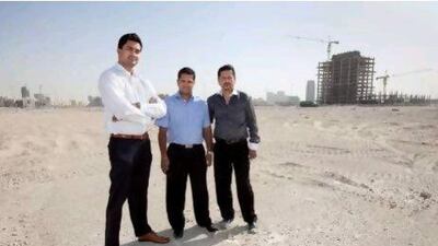 Swarup Anand, Hari Achariya and Debabrai Changkakoic at the site of the Seasons project in Jumeirah Village Circle. They invested in the development, which was never completed.