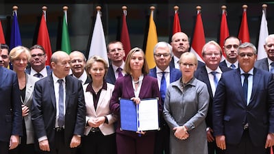EU foreign policy chief Federica Mogherini (C) poses with foreign and defence ministers from 23 EU member states after they signed the notification on Permanent Structure Cooperation (PESCO). Emmanuel Dunand/ EPA