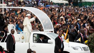 Pope Francis waves as he arrives to celebrate Mass at the University of Nairobi on November 26, 2015. L'Osservatore Romano/Pool Photo via AP