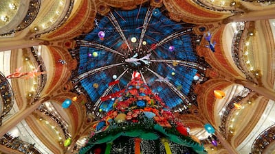 A giant Christmas tree stands at the Galeries Lafayette department store where lights were switched on for the festive season in Paris, France. Reuters