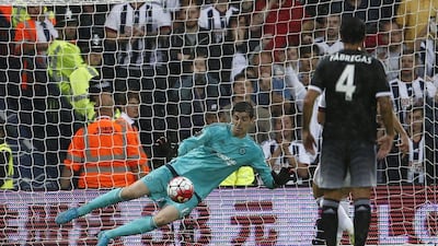 Chelsea keeper Thibaut Courtois stops James Morrison, obscured, from scoring his penalty attempt early in Chelsea's win over West Brom on Sunday. Justin Tallis / AFP