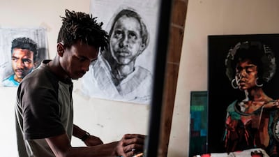 Eritrean artist Nebay Abraha, 23, working on a painting in his room and studio in Addis Ababa. AFP