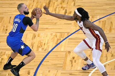 Orlando Magic guard Evan Fournier sets up a shot in front of Miami Heat forward Precious Achiuwa. AP
