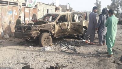 Residents look at an army vehicle, which was damaged during battle between Afghan security forces and Taliban, in Farah province, Afghanistan on May 16, 2018. Reuters