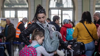 A woman and child in the ticket hall at the railway station in Przemysl, Poland, a gathering point for refugees from Ukraine. AFP