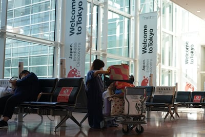 Passengers wait in the arrival lobby of Haneda Airport in Tokyo, Japan, on October 11 after the country reopened borders to international visitors. Bloomberg