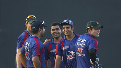 Grand Midwest gather during their semi-finals match against Yogi Group in the Bukhatir Cricket League in Sharjah on Thursday. Jeffrey E Biteng / The National / June 26, 2014