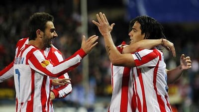 Radamel Falcao, right, celebrates his first goal against Valencia. Angel Martinez / Getty Images