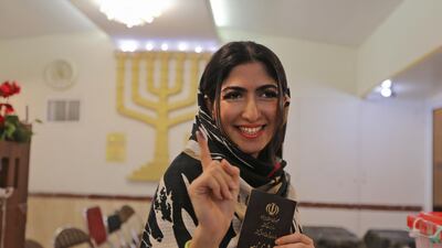 A Jewish Iranian woman shows her ink-stained finger at a polling station in the capital Tehran. AFP