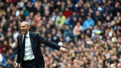 Real Madrid's French coach Zinedine Zidane gestures from the sidelines during the Spanish league football match Real Madrid CF vs Athletic Club Bilbao at the Santiago Bernabeu stadium in Madrid on February 13, 2016. / AFP / GERARD JULIEN