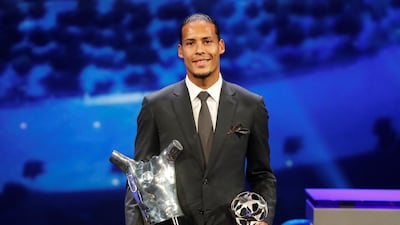 Liverpool's Virgil van Dijk with the Uefa men’s Player of the Year and Champions League Defender of the Season awards. Reuters