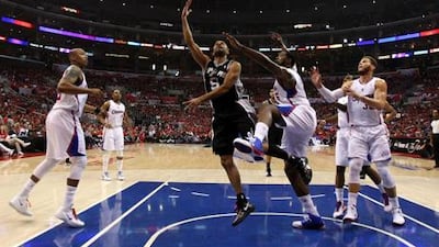 LOS ANGELES, CA - MAY 19: Tony Parker #9 of the San Antonio Spurs shoots over DeAndre Jordan #6 and Blake Griffin #32 of the Los Angeles Clippers in Game Three of the Western Conference Semifinals in the 2012 NBA Playoffs on May 19, 2011 at Staples Center in Los Angeles, California. NOTE TO USER: User expressly acknowledges and agrees that, by downloading and or using this photograph, User is consenting to the terms and conditions of the Getty Images License Agreement. Stephen Dunn/Getty Images/AFP== FOR NEWSPAPERS, INTERNET, TELCOS & TELEVISION USE ONLY ==